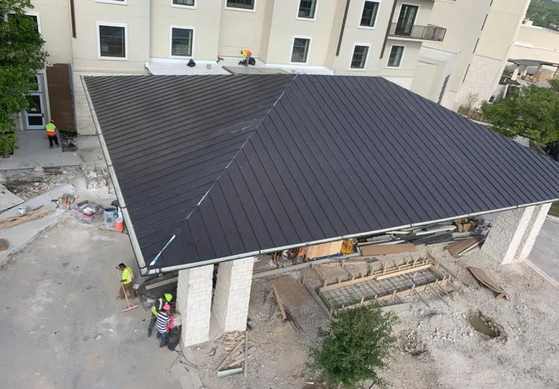 Metal roofing installation team working on a commercial building in Connerton