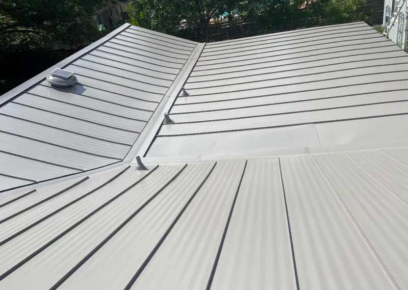 Solar attic fan installed on a metal roof for Roof Ventilation in Connerton